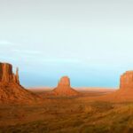 Three sandstone buttes in monument valley desert landscape